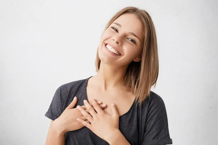 happy woman hands to heart attitude of gratitudethings I have learned about appreciation and the minimalist lifestyle