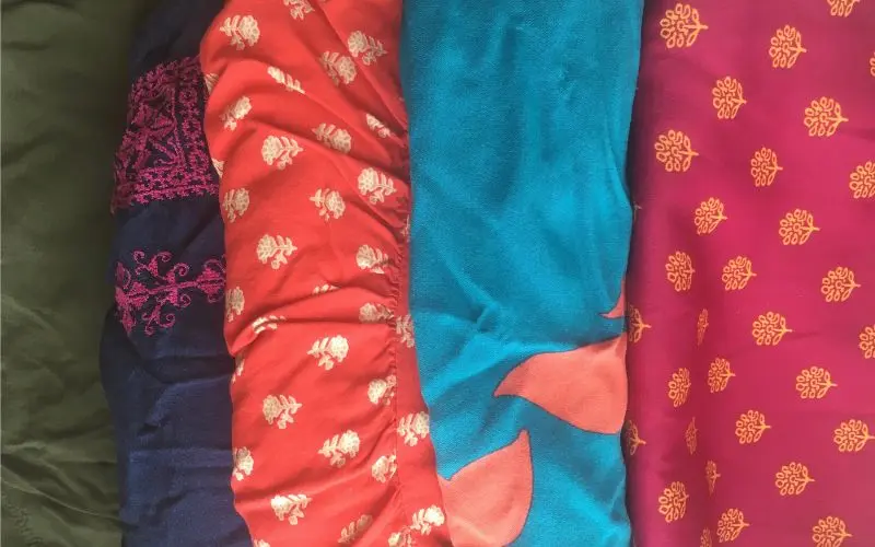 stack of my colorful minimalist wardrobe tops