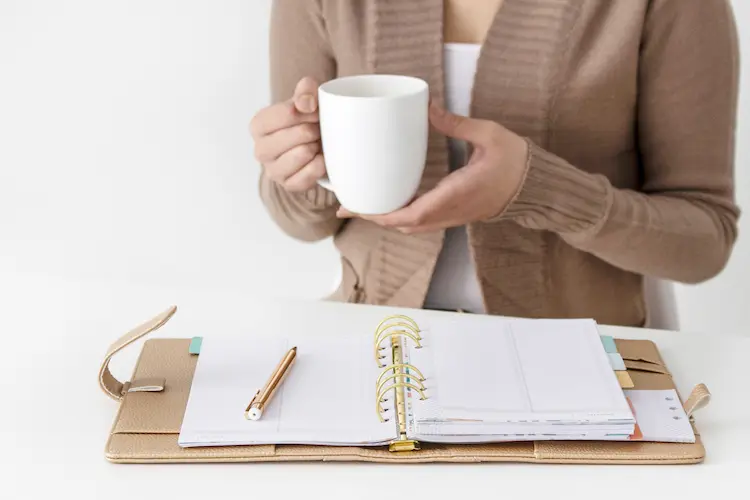 woman with cup and planner