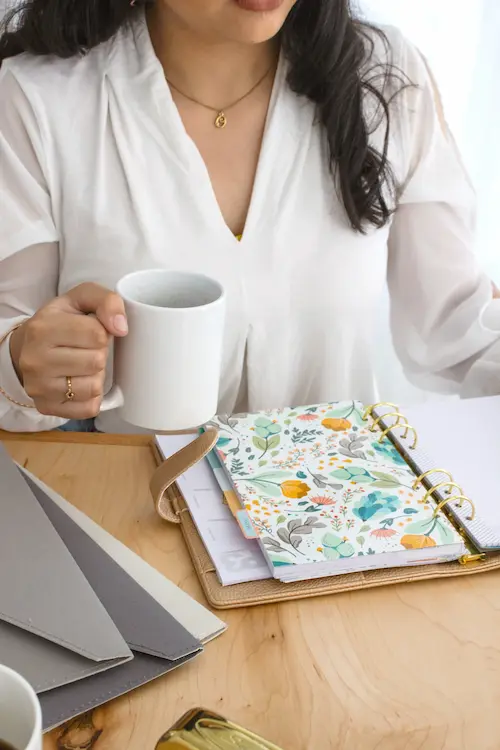 woman with cup and floral planner