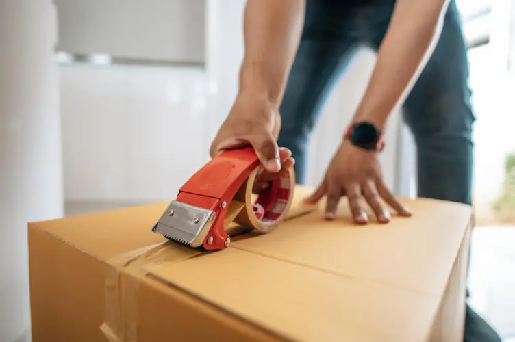 man taping up box

things to declutter
