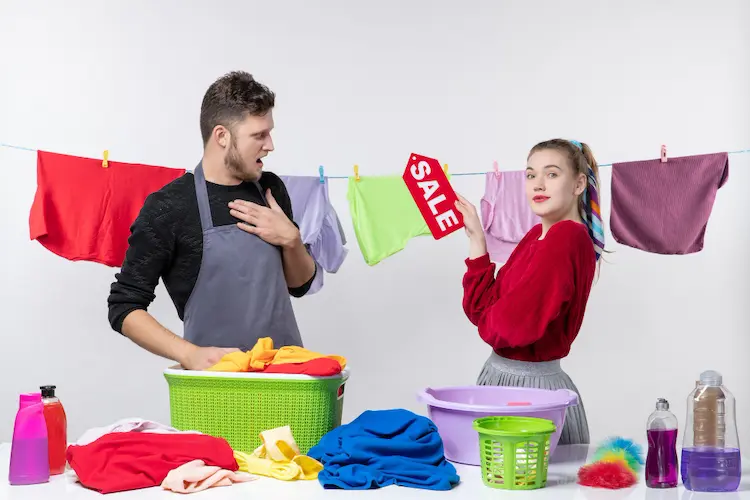 confused man woman with sale sign doing house work