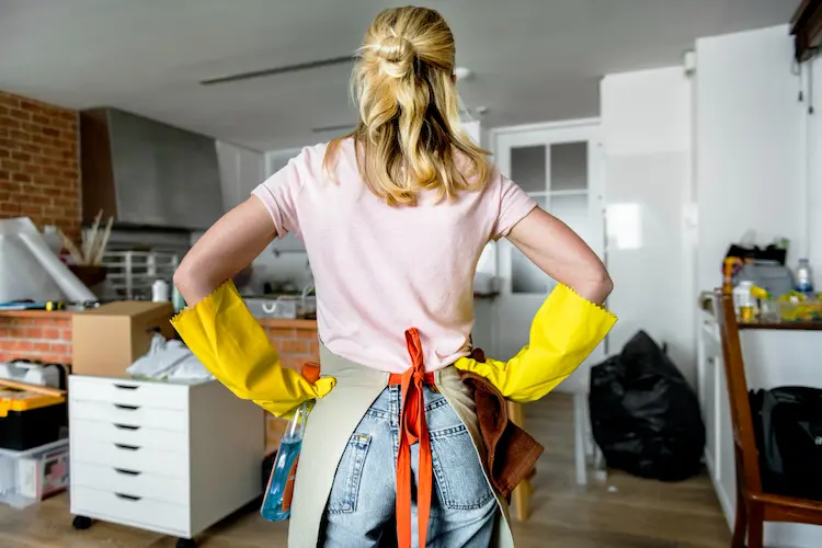 woman cleaning house cluttered
