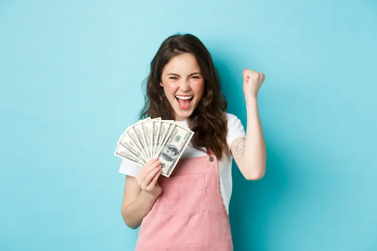 happy woman holding money