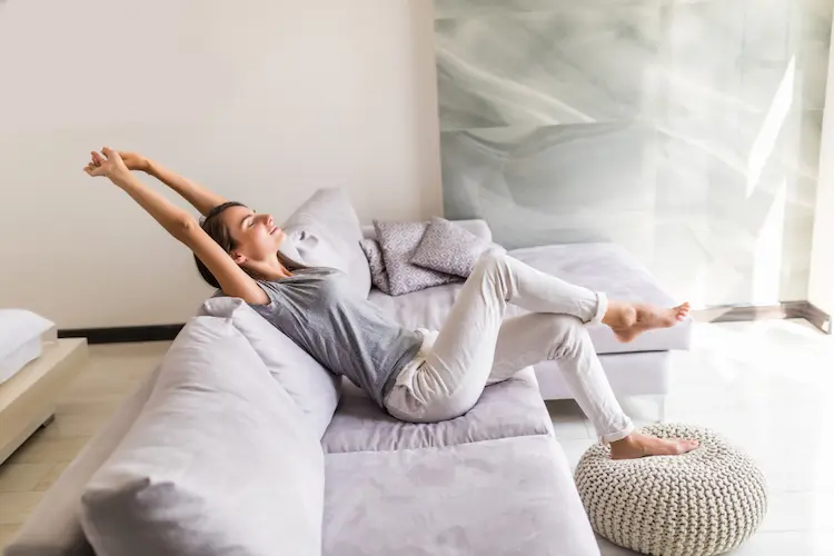 smiling woman relaxing on couch
managing anxiety with minimalism
