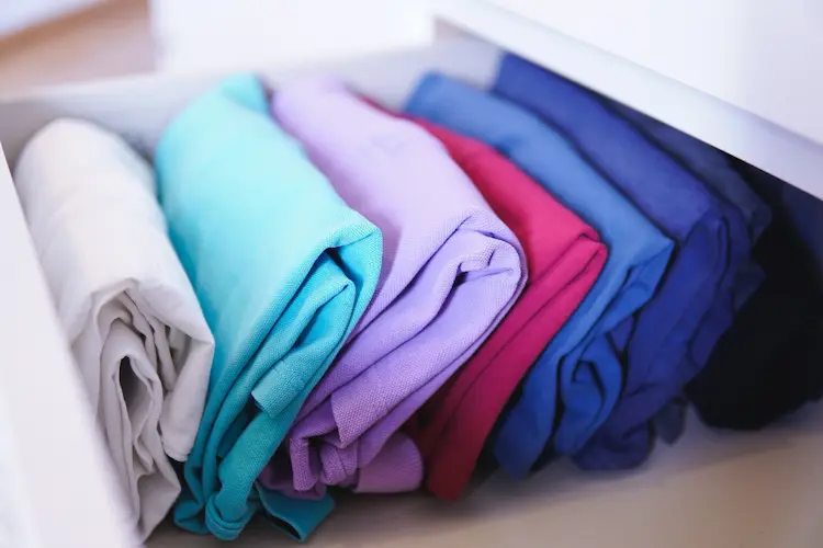 kondo file folded clothing in drawer
colorful minimalist wardrobe
minimalist fashion colors
