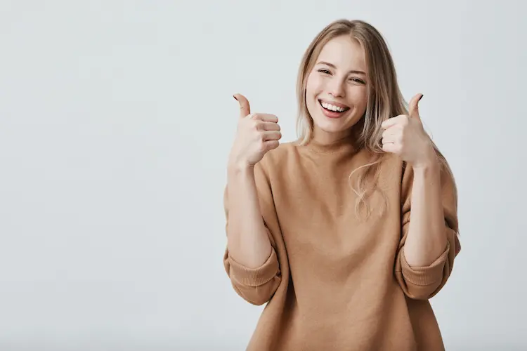 woman with two thumbs up and big smile