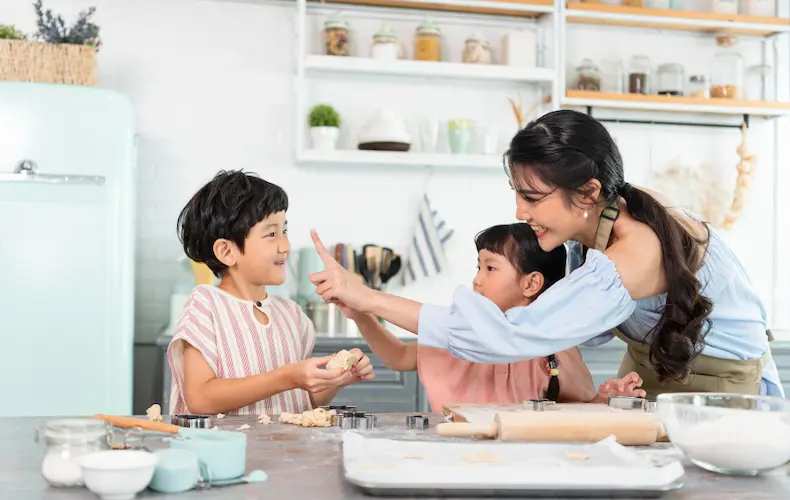 asian family baking together in kitchen