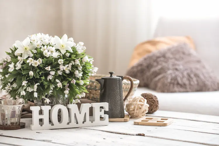 coffee table with flowers and tea pitcher