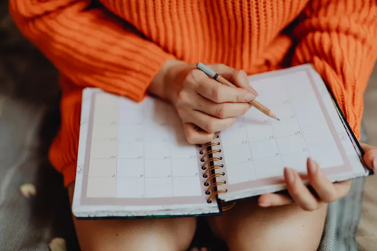 woman writing in planner