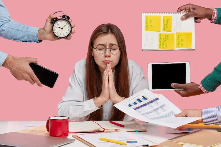 overwhelmed woman being handed too many tasks at once