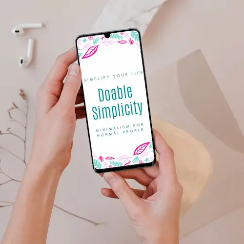 Doable Simplicity Ebook on phone in womans hands