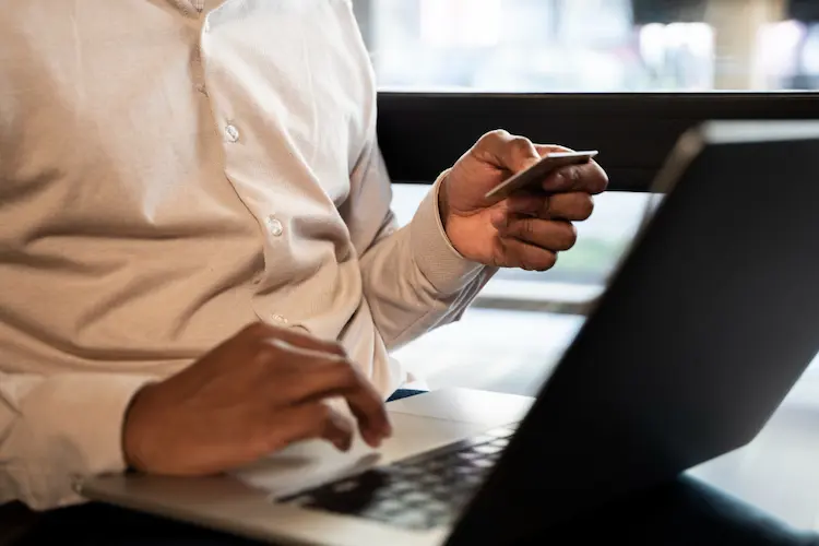 close up man on lap top with credit card online shopping research

live debt free
