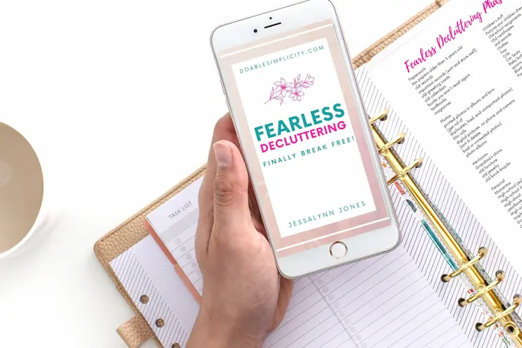 fearless decluttering ebook on phone and notebook binder with printables that will help simplify your life