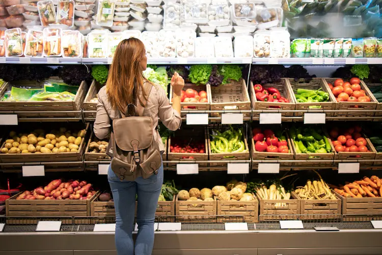 woman in grocery story produce grocery shopping

minimalism save money 