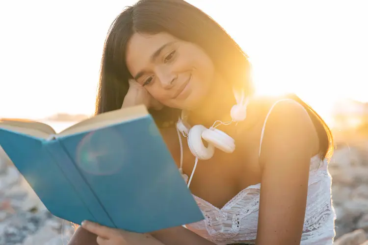 girl reading sunset beach