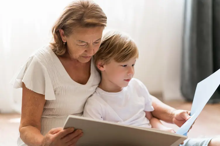 grandmother showing pictures to grandson

