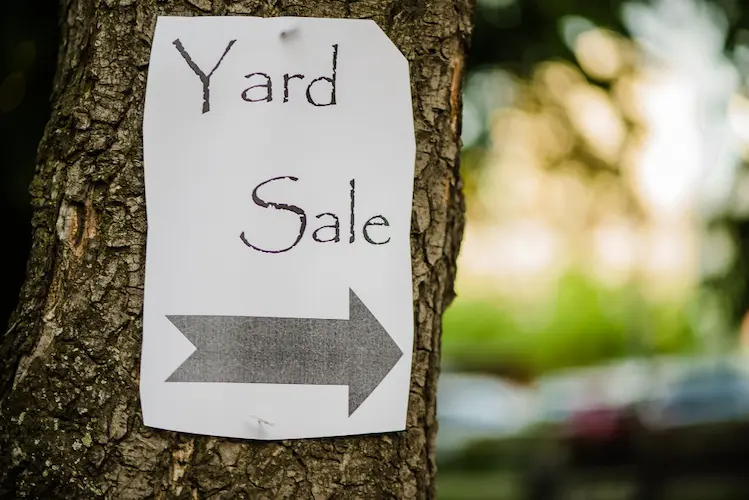 yard sale sign paper on tree