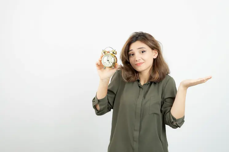 confused woman holding clock hands up