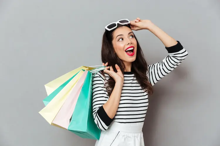 cheerful woman with shopping bags
 how to stop spending money on clothes
