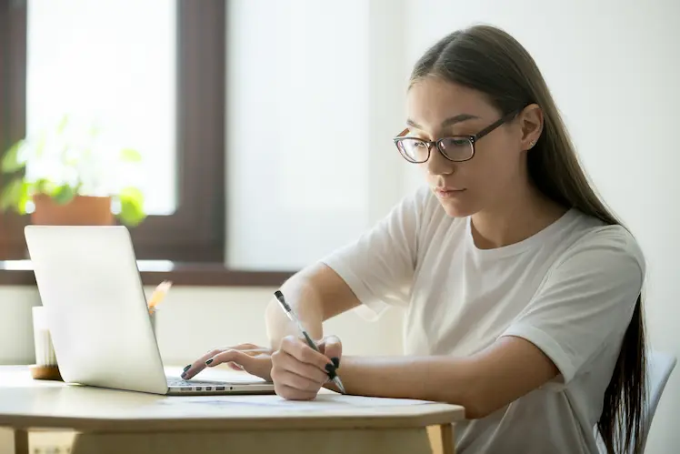 serious student researching on computer