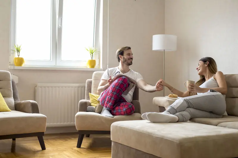 couple in pjs talking in house
